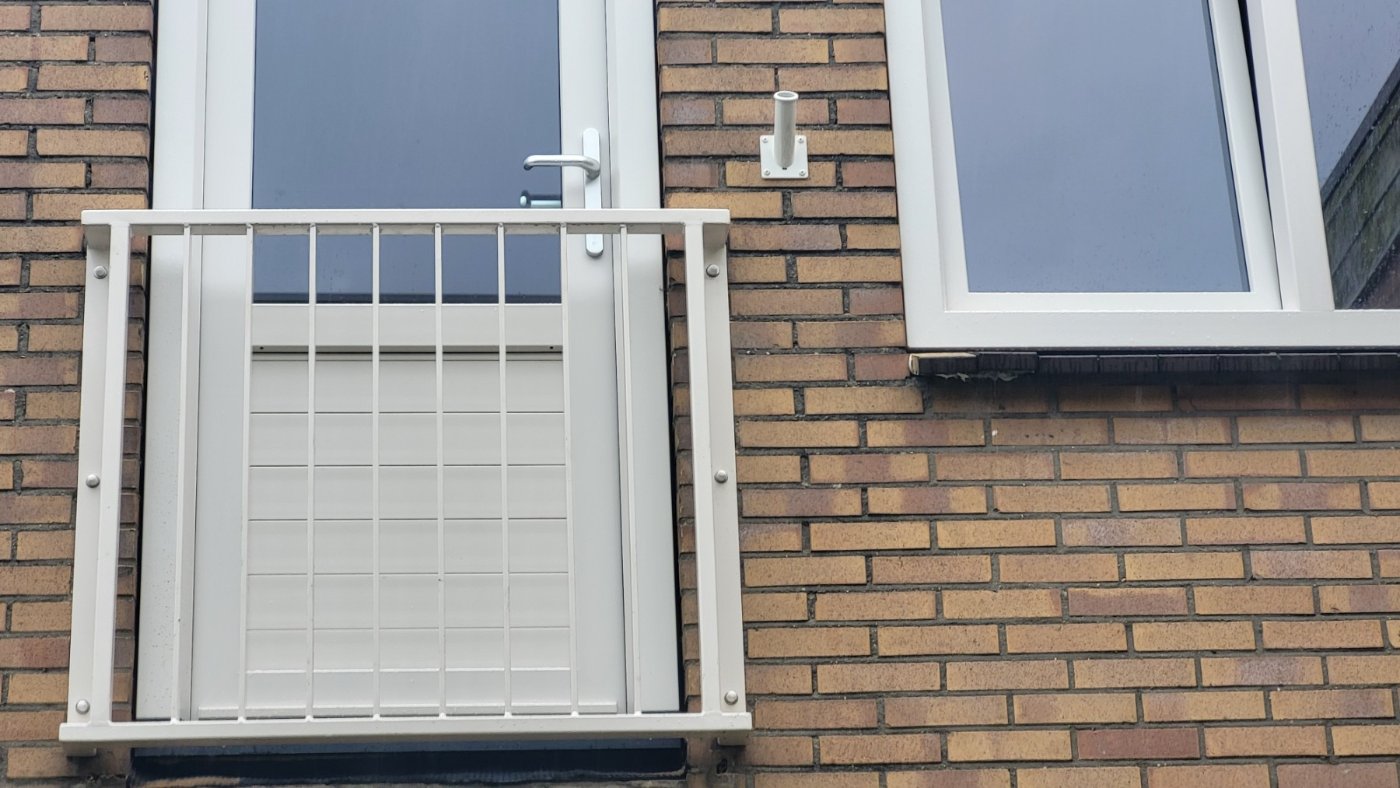 Frans balkon in RAL 9001 cremewit voor de openslaande deuren van een woning in Huizen